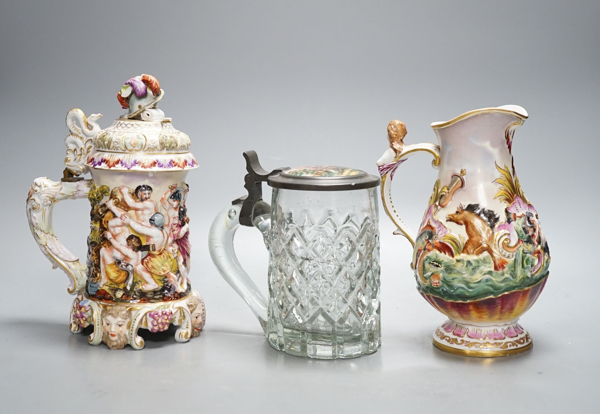 An Italian porcelain lidded tankard and matching jug, together with a cut glass lidded tankard with porcelain inset pewter lid, 22cm